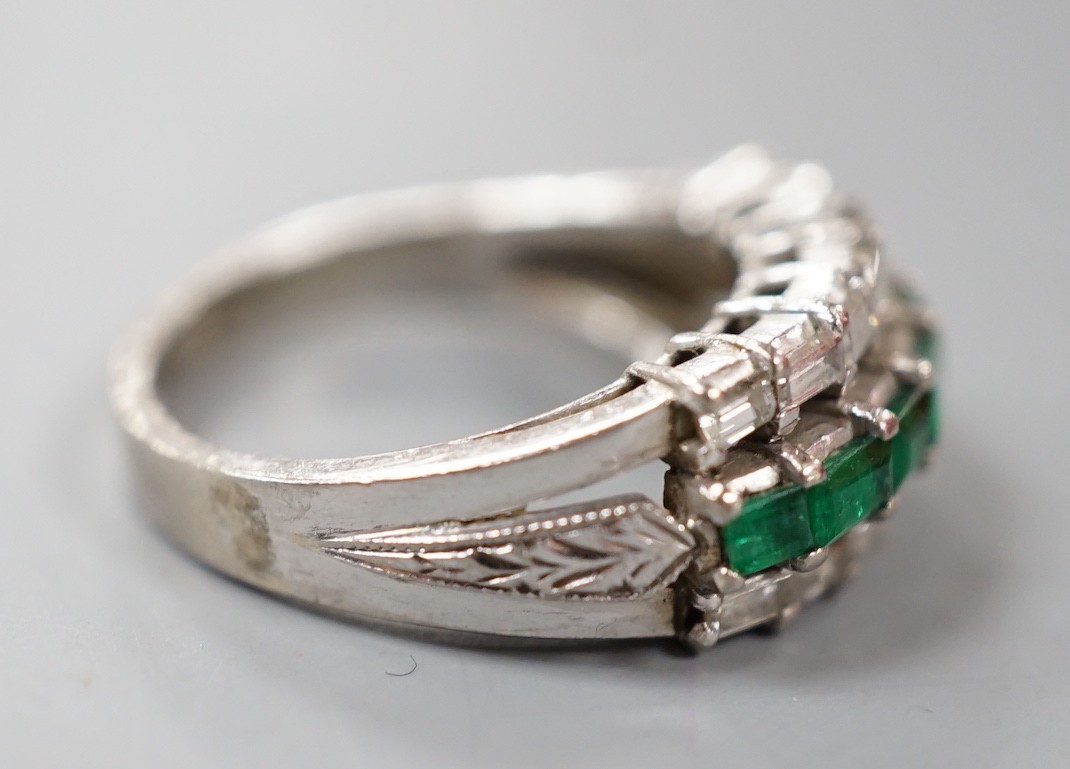 A modern 18k white metal, emerald and baguette cut diamond set three row half hoop ring (shank cut), size L, gross weight 5 grams.